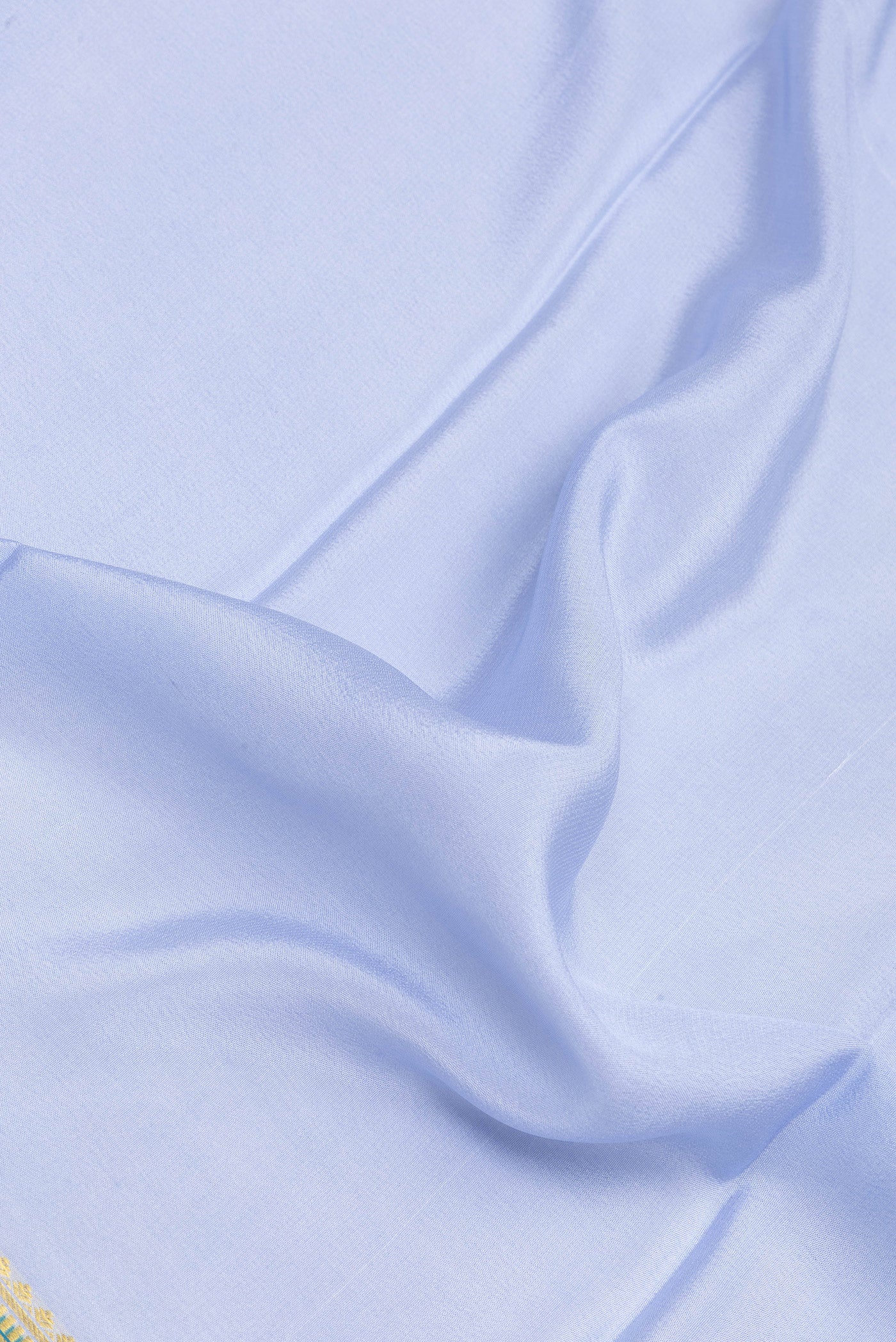 Close up of Maya Blue Mysore Silk Saree with Plain Body and Zari Border.  displaying folds