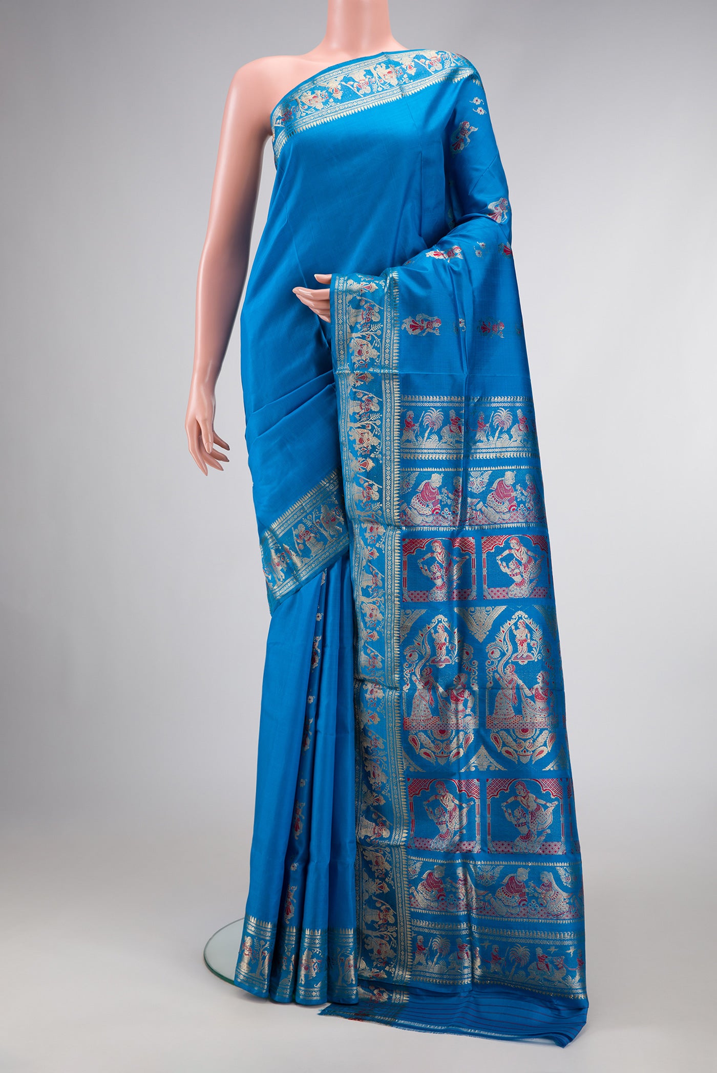 Sky Blue Dual Tone Baluchari Silk Saree with Zari And Thread Butta on the body and Fancy Border.  displayed on a mannequin