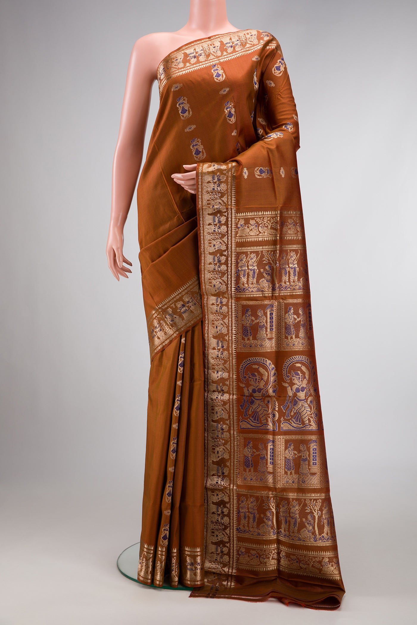 Caramel Dual Tone Baluchari Silk Saree with Zari And Thread Butta on the body and Fancy Border.  displayed on a mannequin