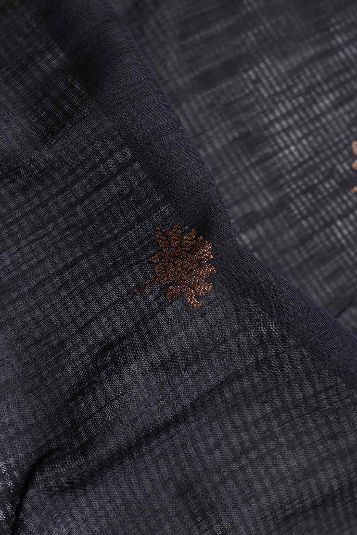 Close up of Black Dual Tone Tussar Saree with Zari Butta on the body and Zari Border.  displaying folds