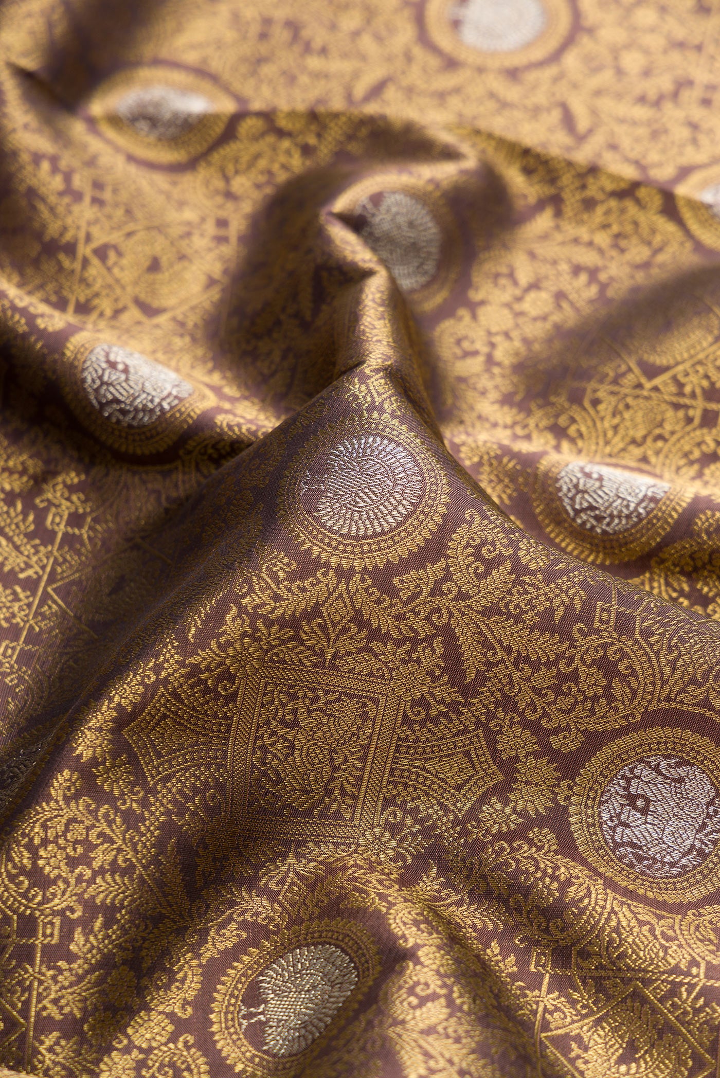 Close up of Pure Silk Pure Zari Brown Dual Tone Kanjivaram Saree with Zari Brocade on the body and Zari Border.  displaying folds
