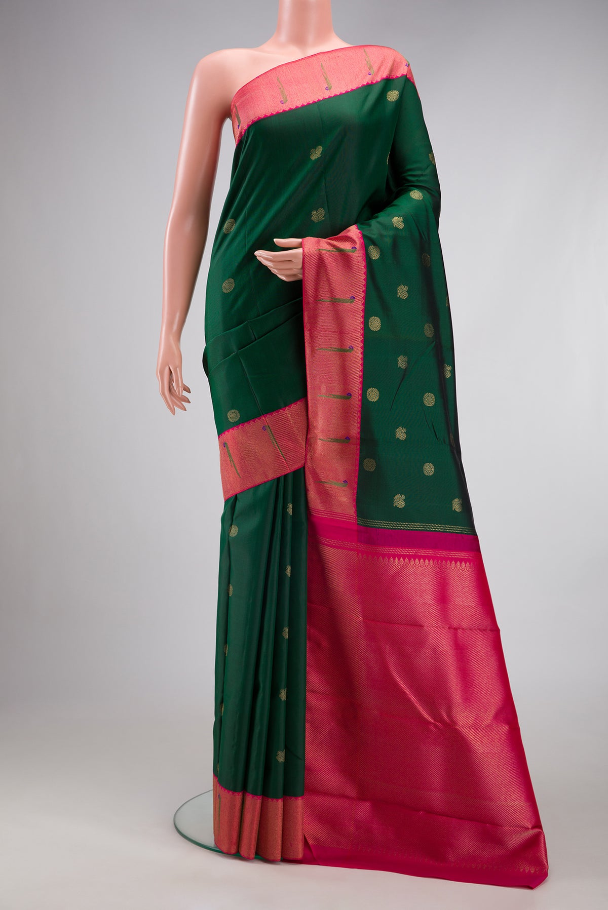 Pure Silk Pure Zari Bottle Green Kanjivaram Saree with Zari Butta on the body and Paithani Border.  displayed on a mannequin