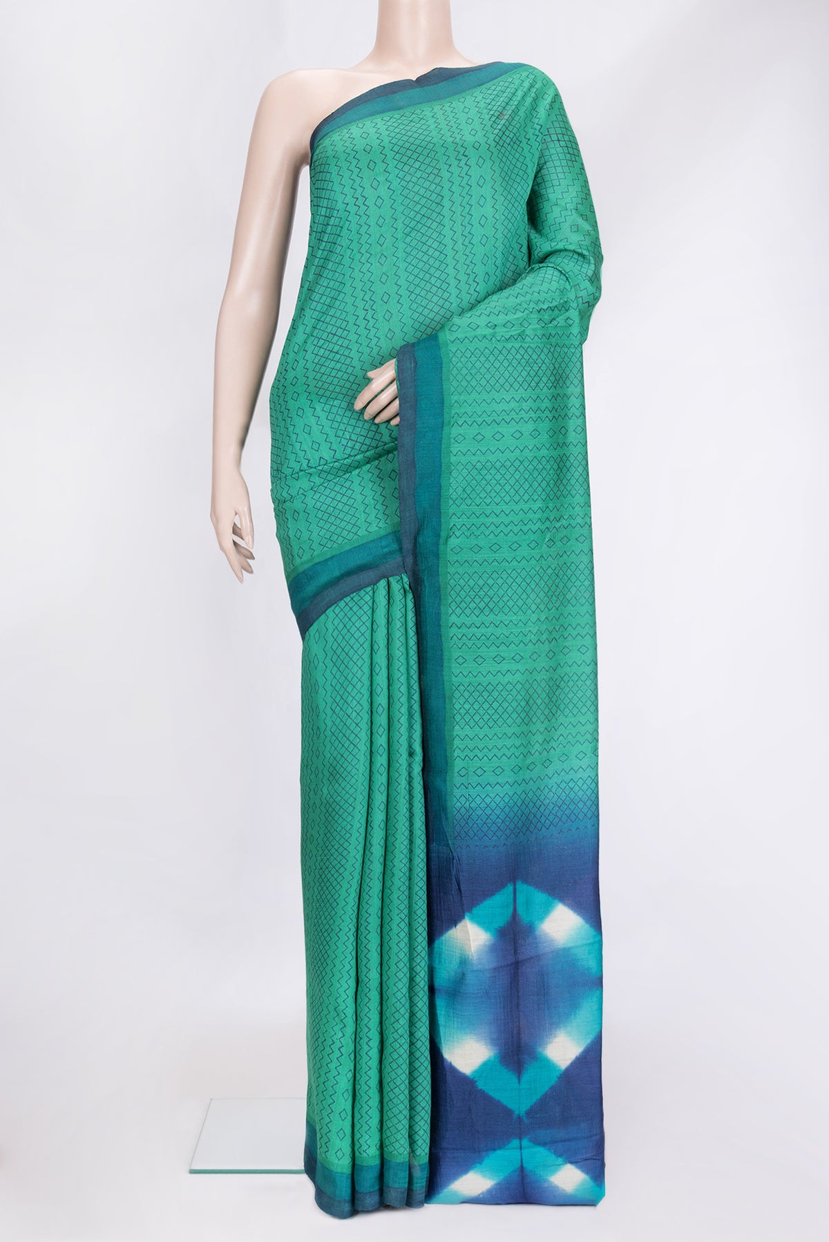 Sea Green Dual Tone Tussar Silk Saree with Printed design on the body and Plain Border.  displayed on a mannequin