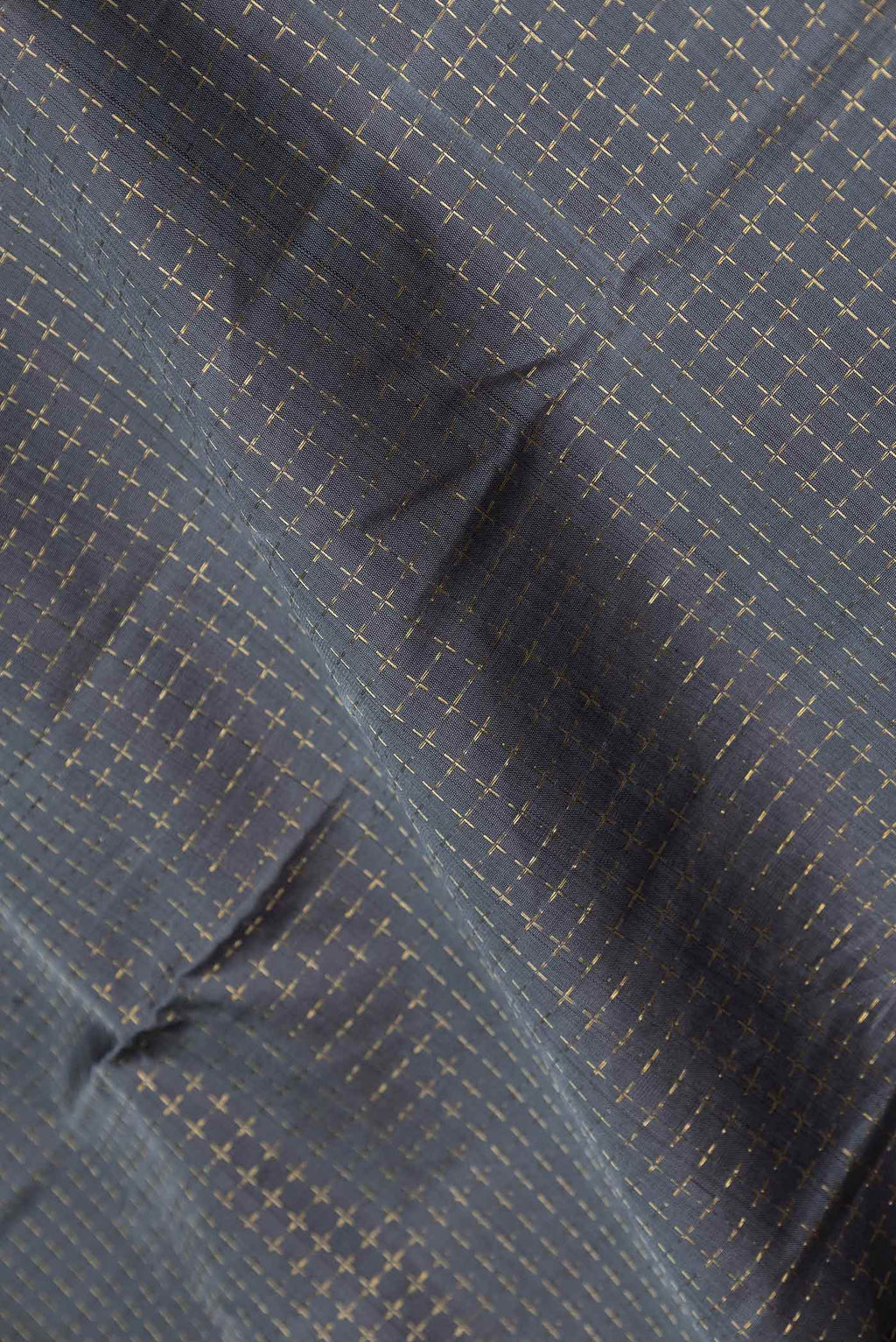 Close up of Grey Dual Tone Kanchipuram Silk Saree with Checked design on the body and Zari Border displaying folds