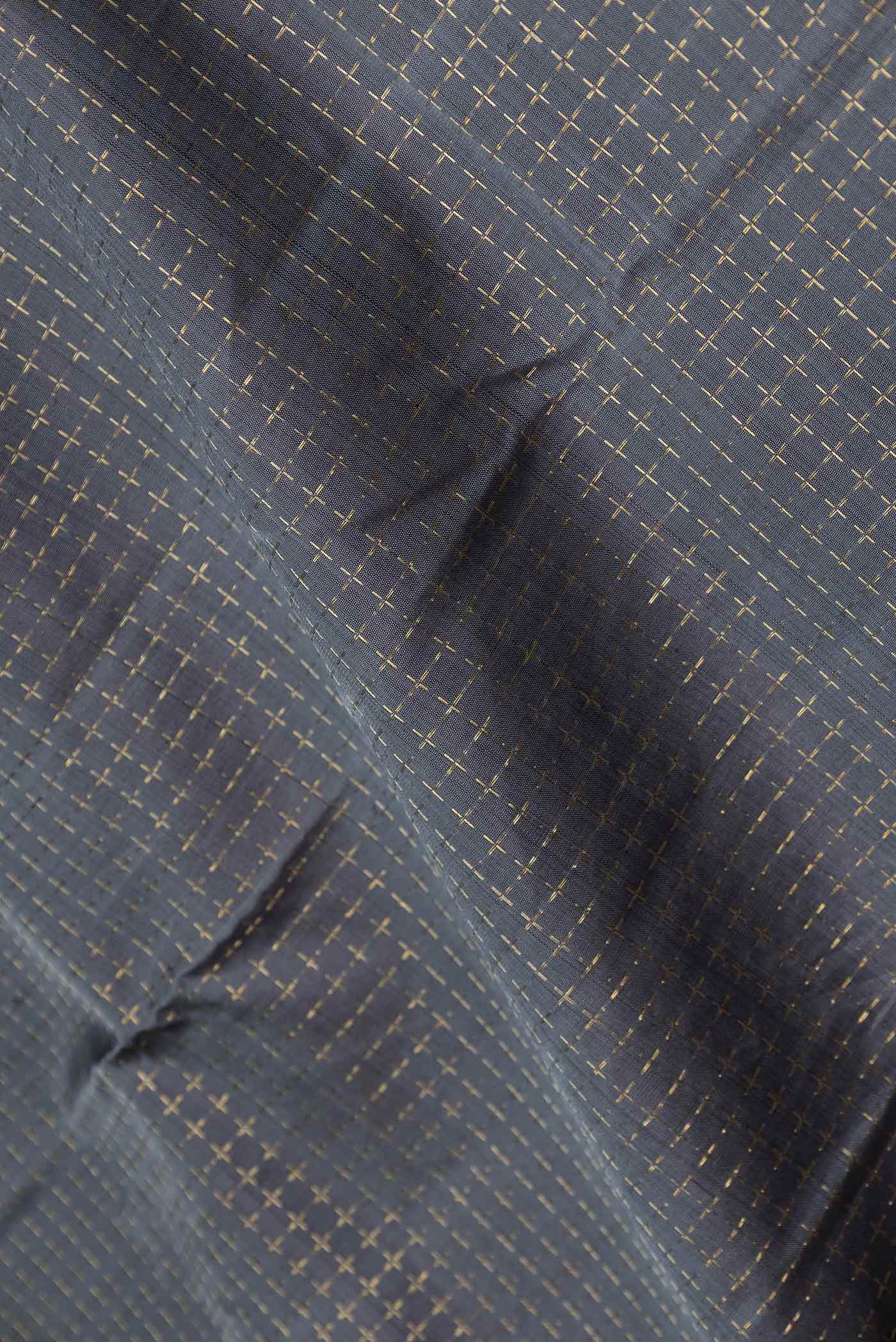 Close up of Grey Dual Tone Kanchipuram Silk Saree with Checked design on the body and Zari Border displaying folds