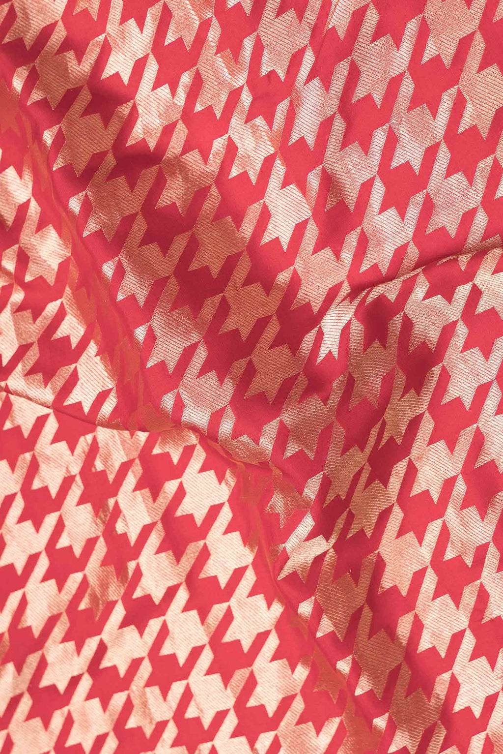 Close up of Red Dual Tone Banarasi Silk Saree with Zari Brocade on the body and Zari Border.  displaying folds