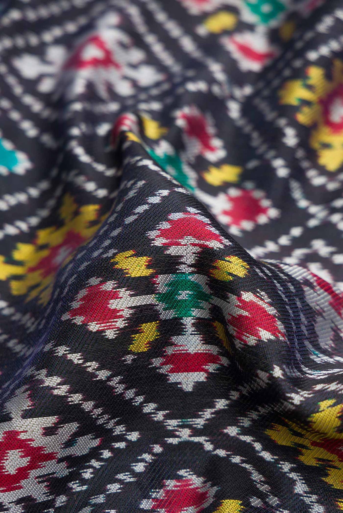 Close up of Black Pochampally Silk Saree with Pure Ikat on the body and Plain Border displaying folds