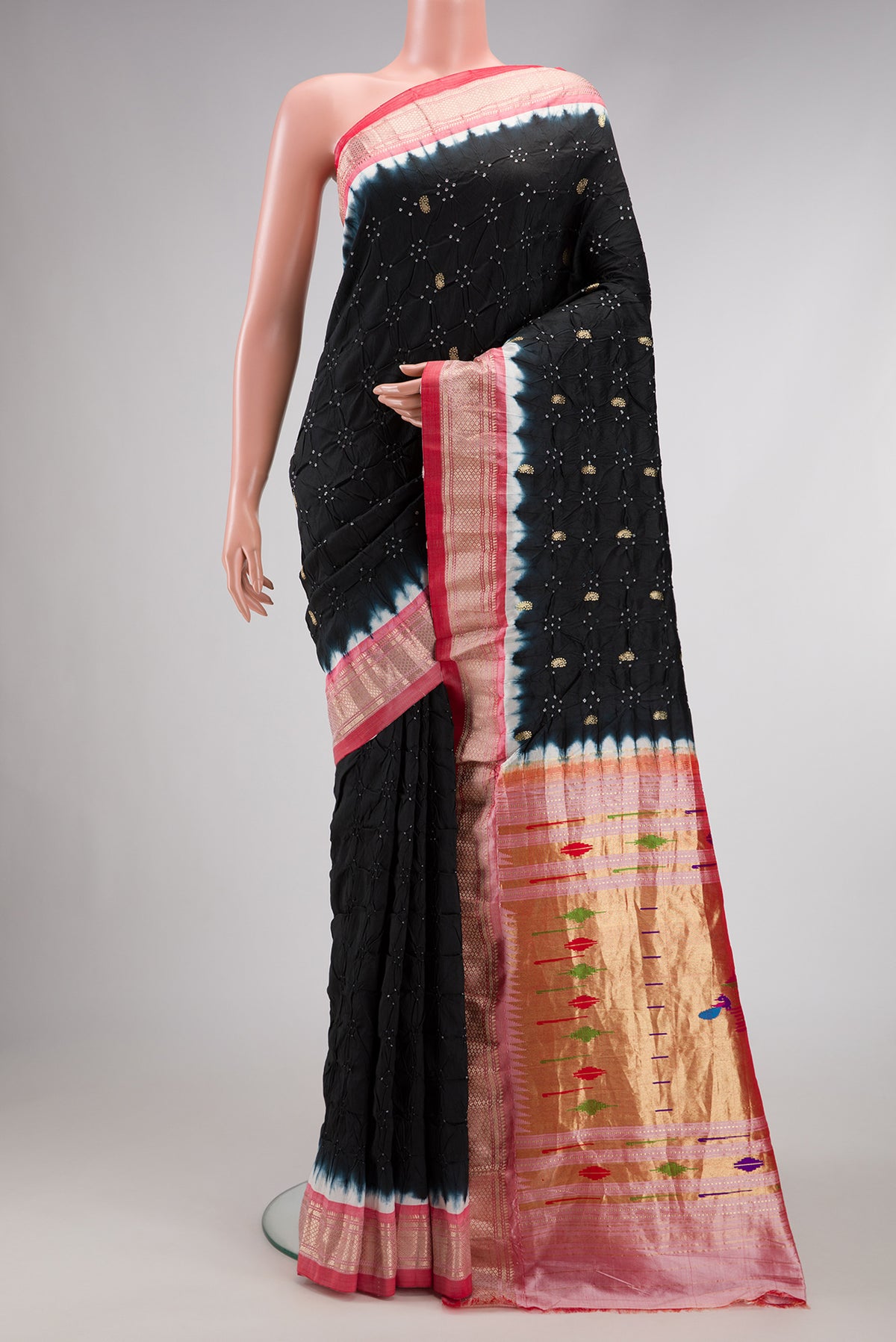 Black Dual Tone Bandhani Silk Saree with Bandhani Print on the body and Zari Border.  displayed on a mannequin