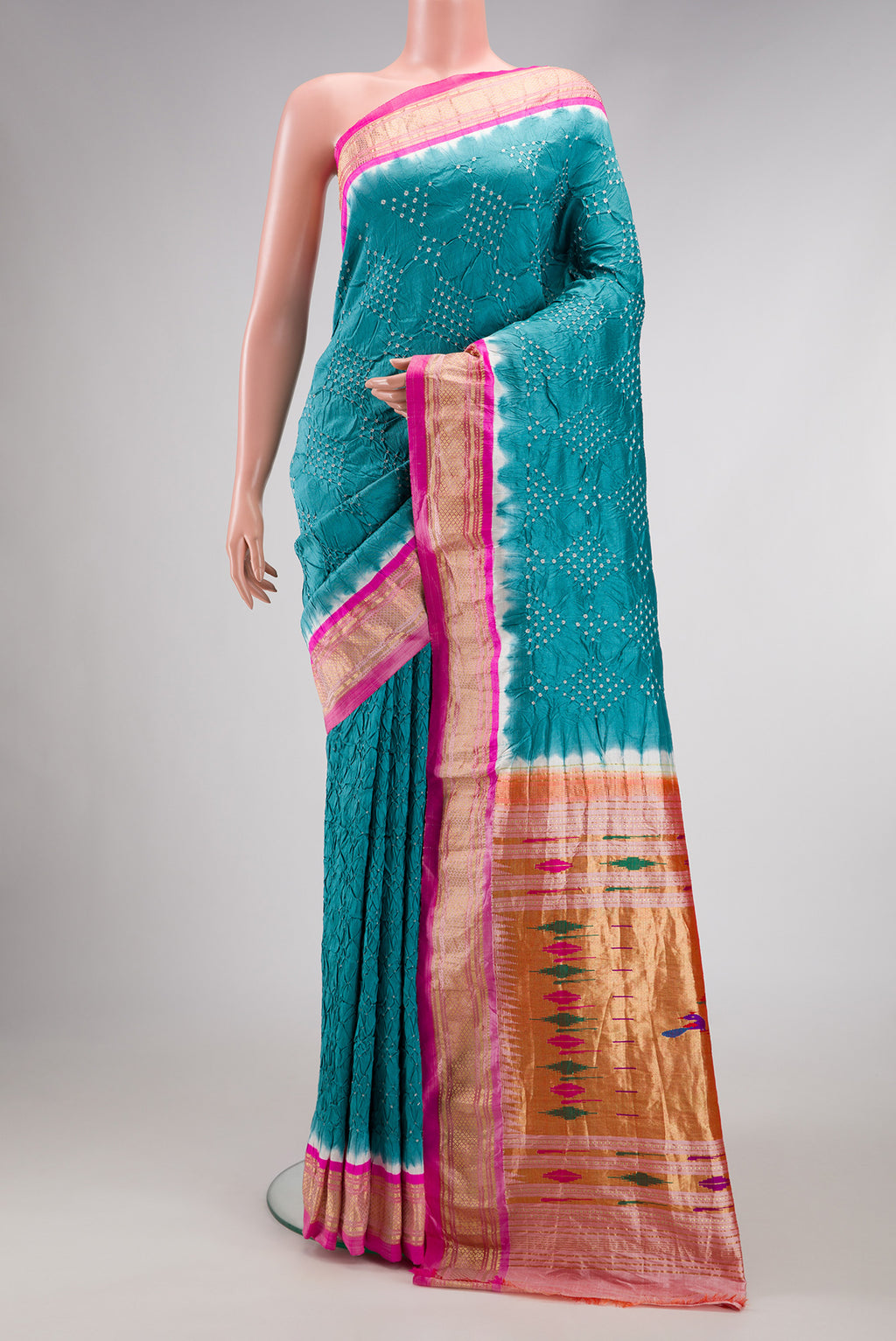 Peacock Blue Dual Tone Bandhani Silk Saree with Bandhani Print on the body and Zari Border.  displayed on a mannequin