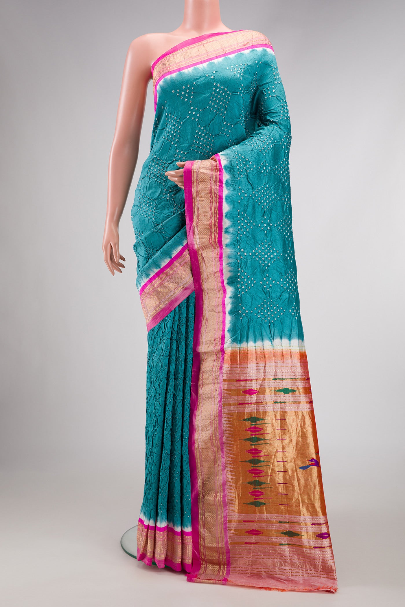 Peacock Blue Dual Tone Bandhani Silk Saree with Bandhani Print on the body and Zari Border.  displayed on a mannequin