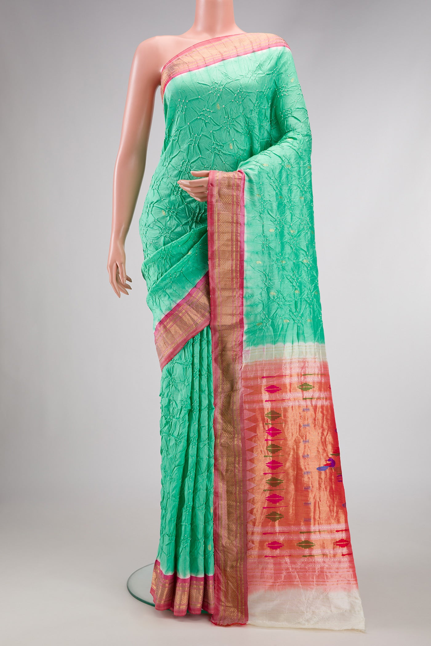 Sea Green Dual Tone Bandhani Silk Saree with Bandhani Print on the body and Zari Border.  displayed on a mannequin