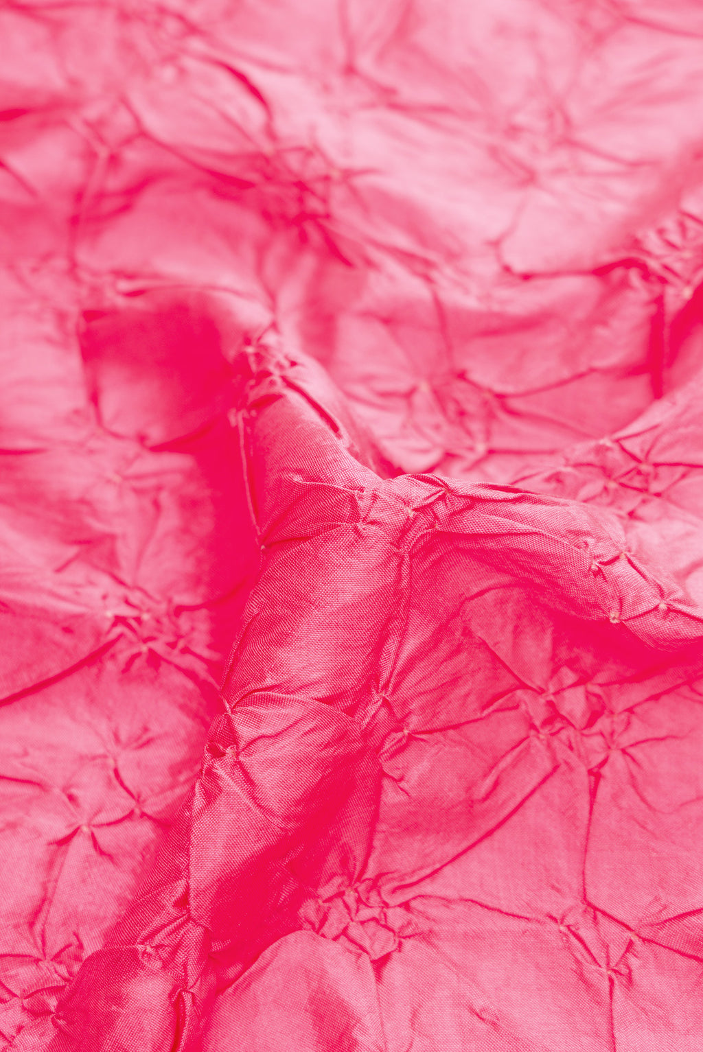 Close up of Pink Dual Tone Bandhani Silk Saree with Bandhani Print on the body and Zari Border.  displaying folds