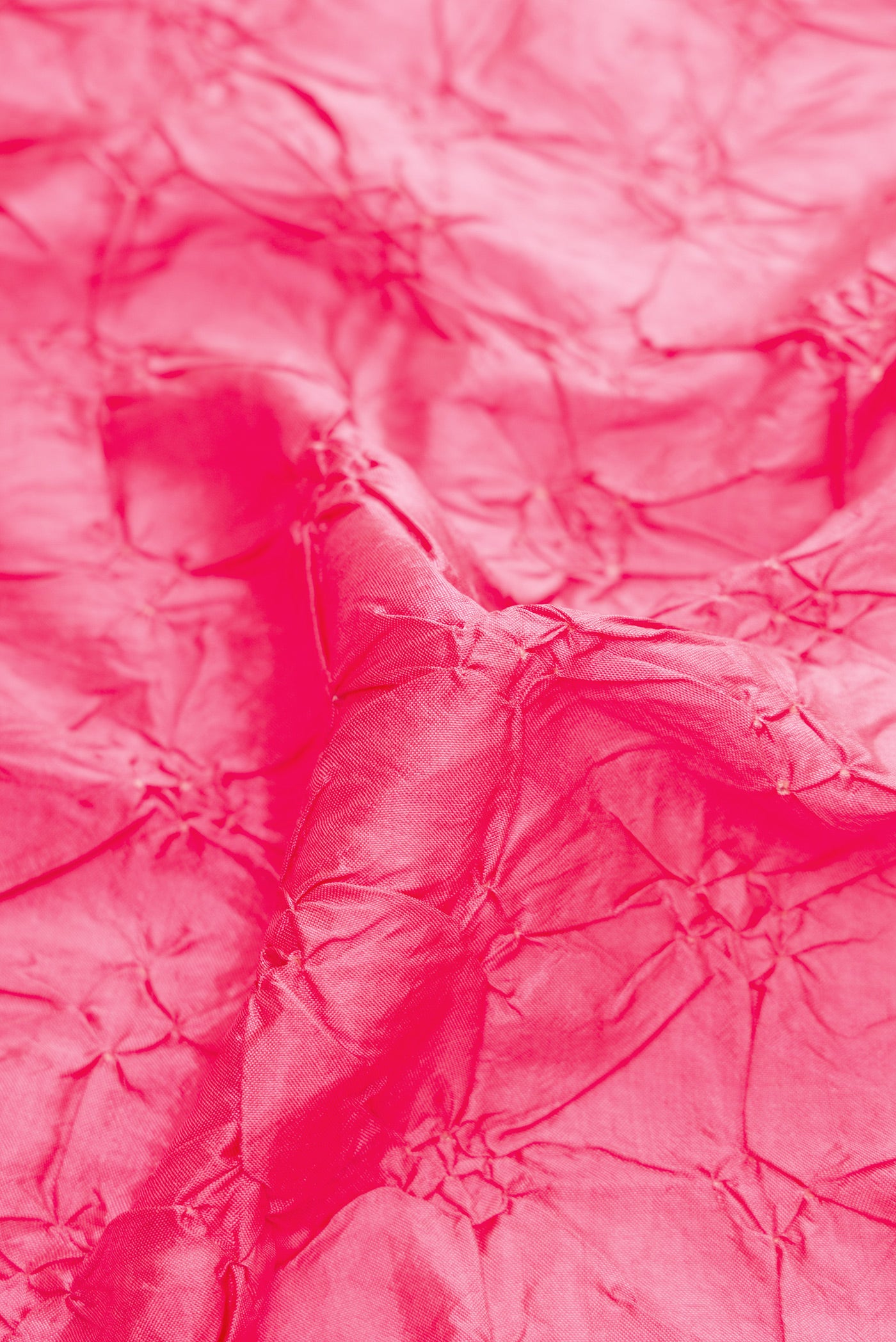 Close up of Pink Dual Tone Bandhani Silk Saree with Bandhani Print on the body and Zari Border.  displaying folds