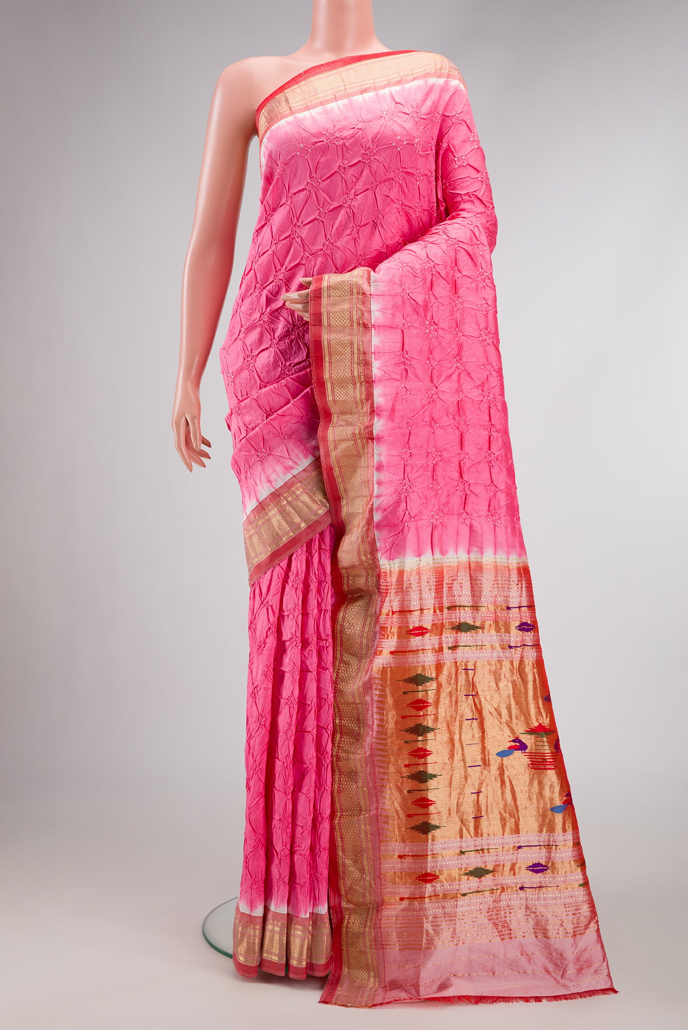 Pink Dual Tone Bandhani Silk Saree with Bandhani Print on the body and Zari Border.  displayed on a mannequin
