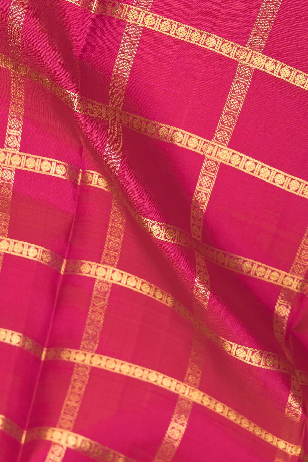 Close up of Pink Dual Tone Kanchipuram Saree with Checked design on the body and Without Border displaying folds