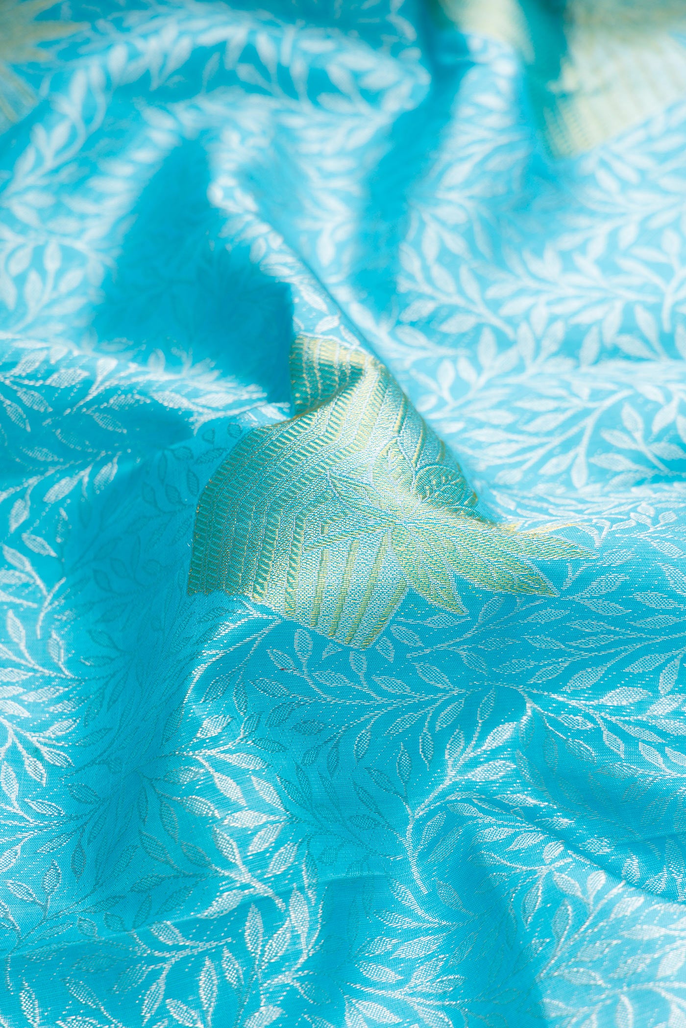 Close up of Sky Blue Dual Tone Kanjivaram Silk Saree with Zari Brocade on the body and Without Border.  displaying folds