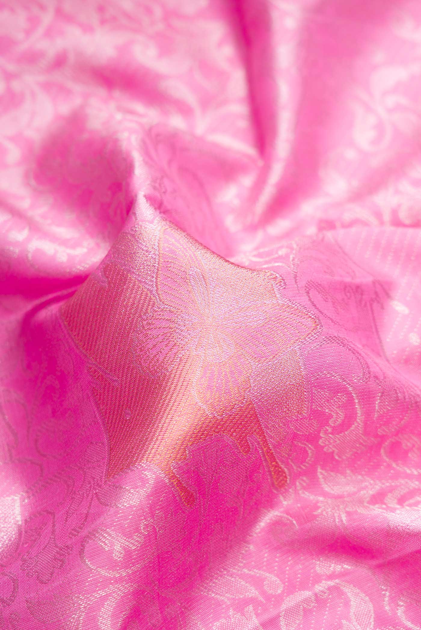 Close up of Pink Dual Tone Kanjivaram Silk Saree with Zari Brocade on the body and Without Border.  displaying folds