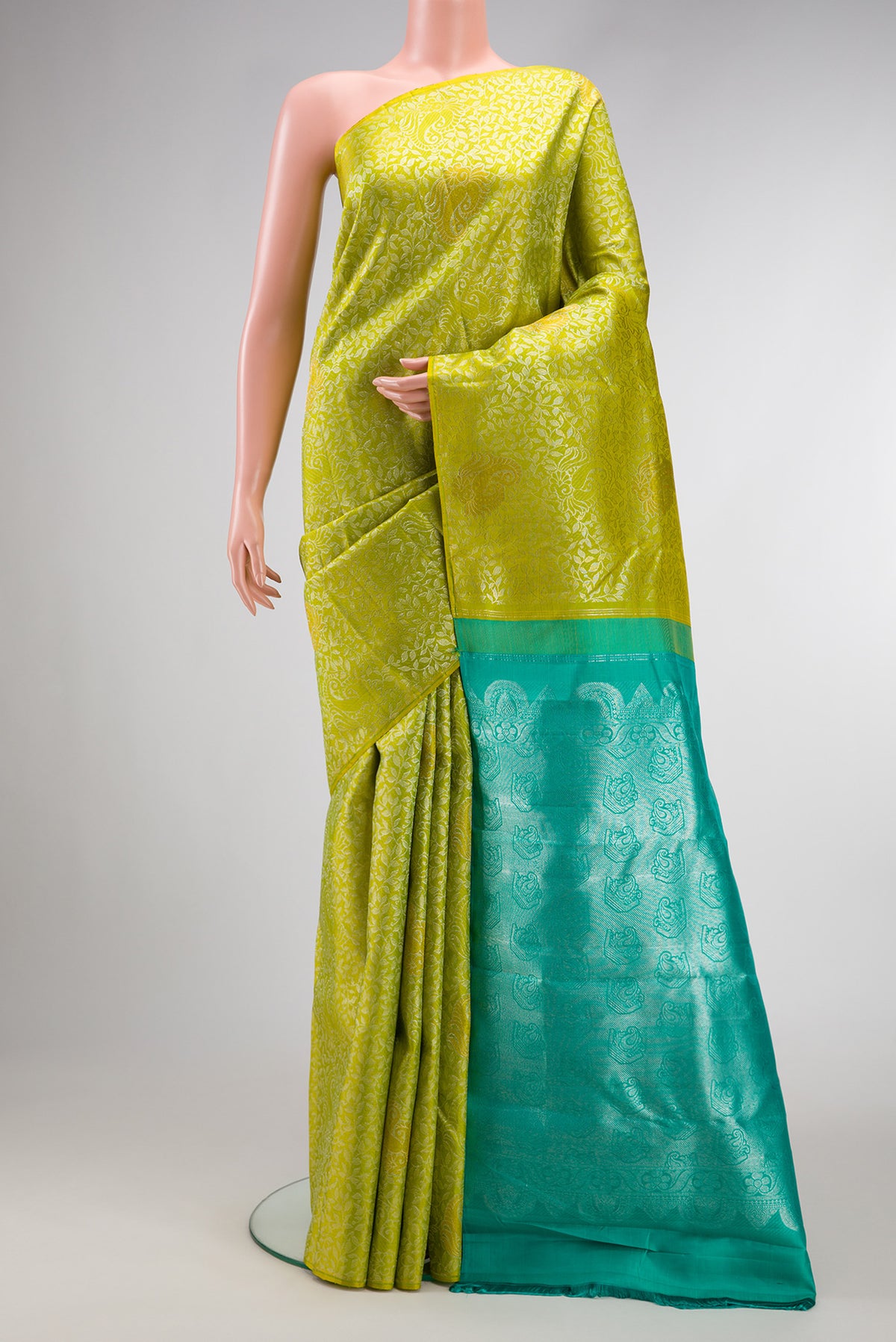 Parrot Green Dual Tone Kanjivaram Silk Saree with Zari Brocade on the body and Without Border.  displayed on a mannequin