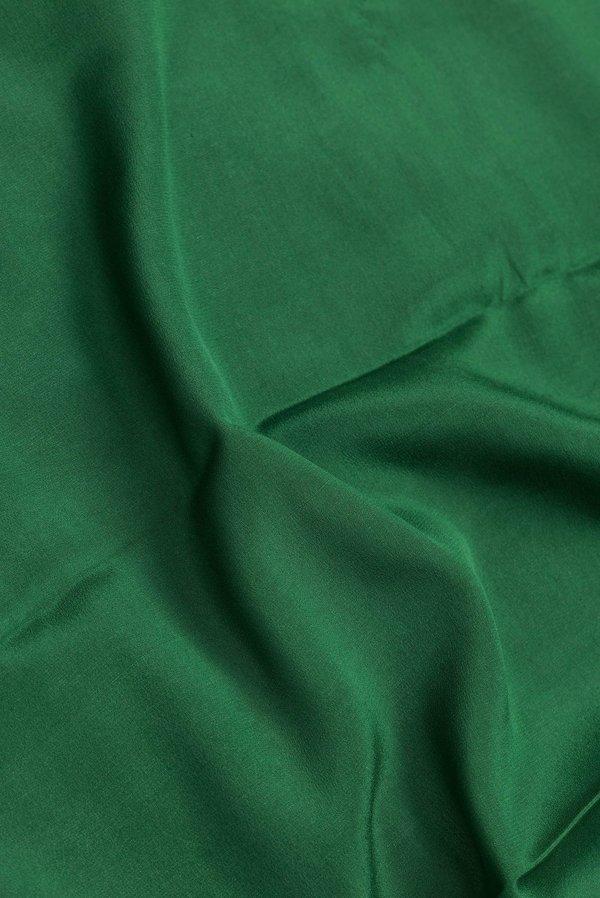 Close up of Bottle Green Dual Tone Mysore Georgette Saree with Plain Body and Zari Border.  displaying folds