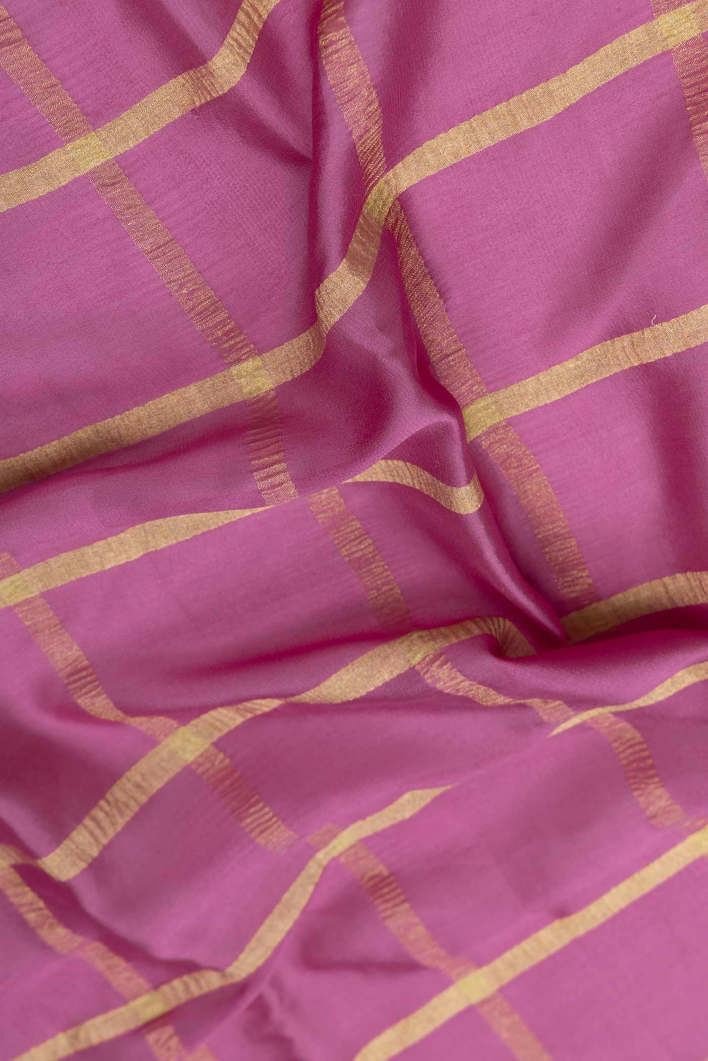Close up of Light Magenta Mysore Crepe Saree with Checked design on the body and Zari Border displaying folds
