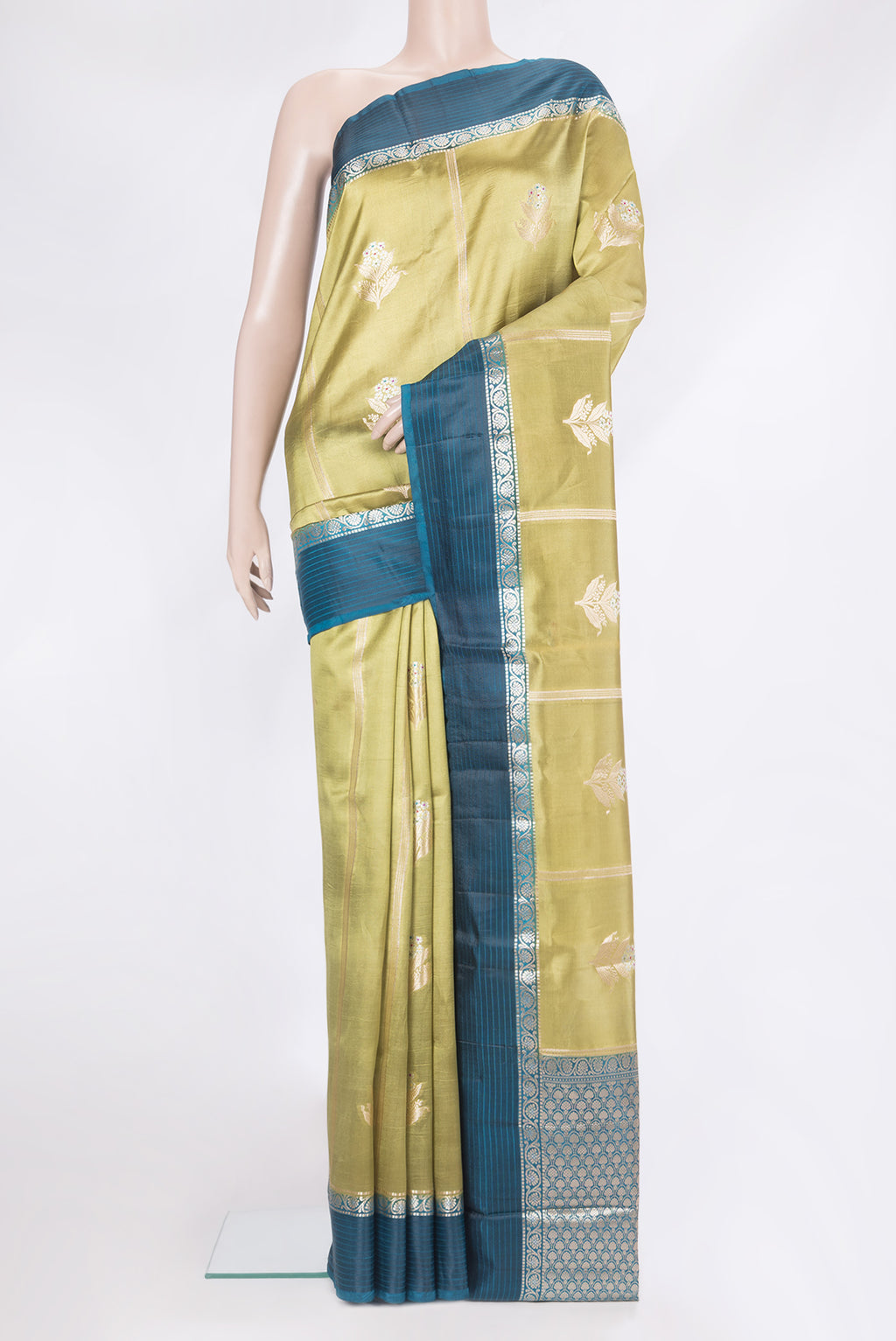 Green Tussar Silk Saree with Zari Butta on the body and Zari Border.  displayed on a mannequin