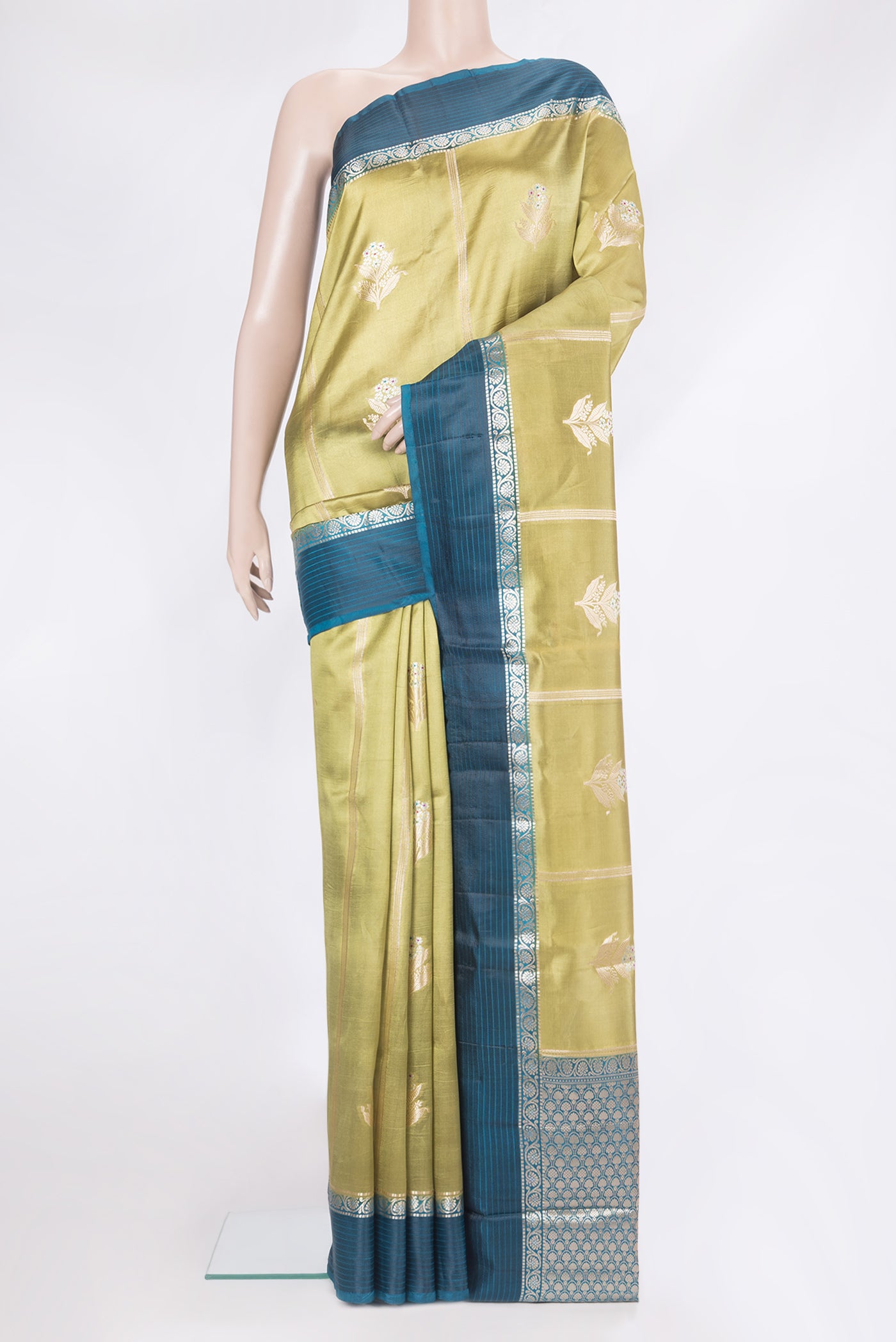 Green Tussar Silk Saree with Zari Butta on the body and Zari Border.  displayed on a mannequin