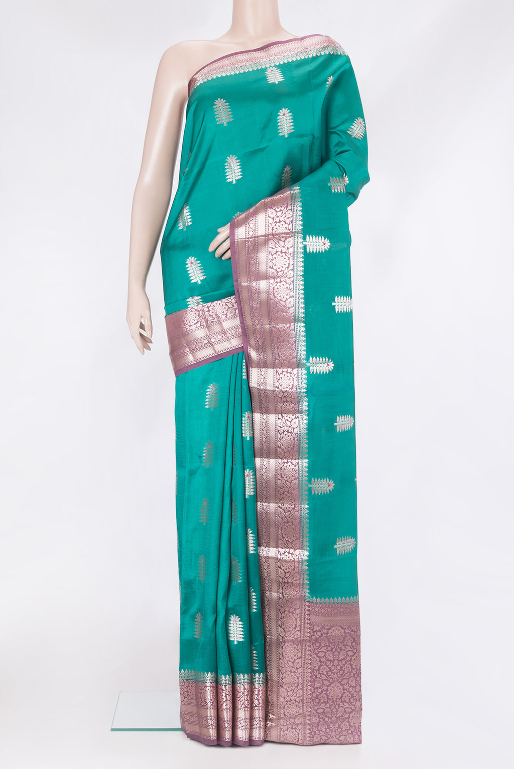 Green Tussar Silk Saree with Zari Butta on the body and Zari Border.  displayed on a mannequin