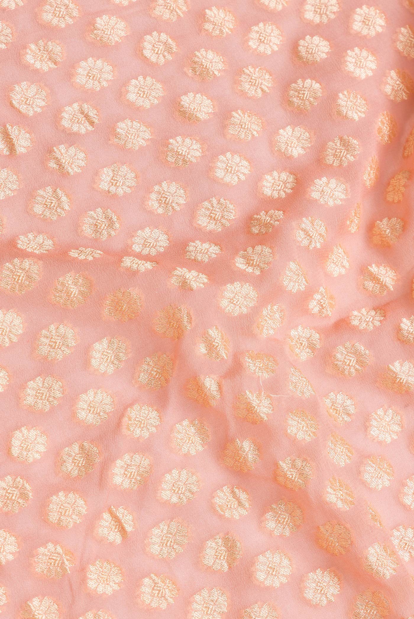 Close up of Golden Peach Dual Tone Banarasi Georgette Saree with Zari Brocade on the body and Zari Border.  displaying folds