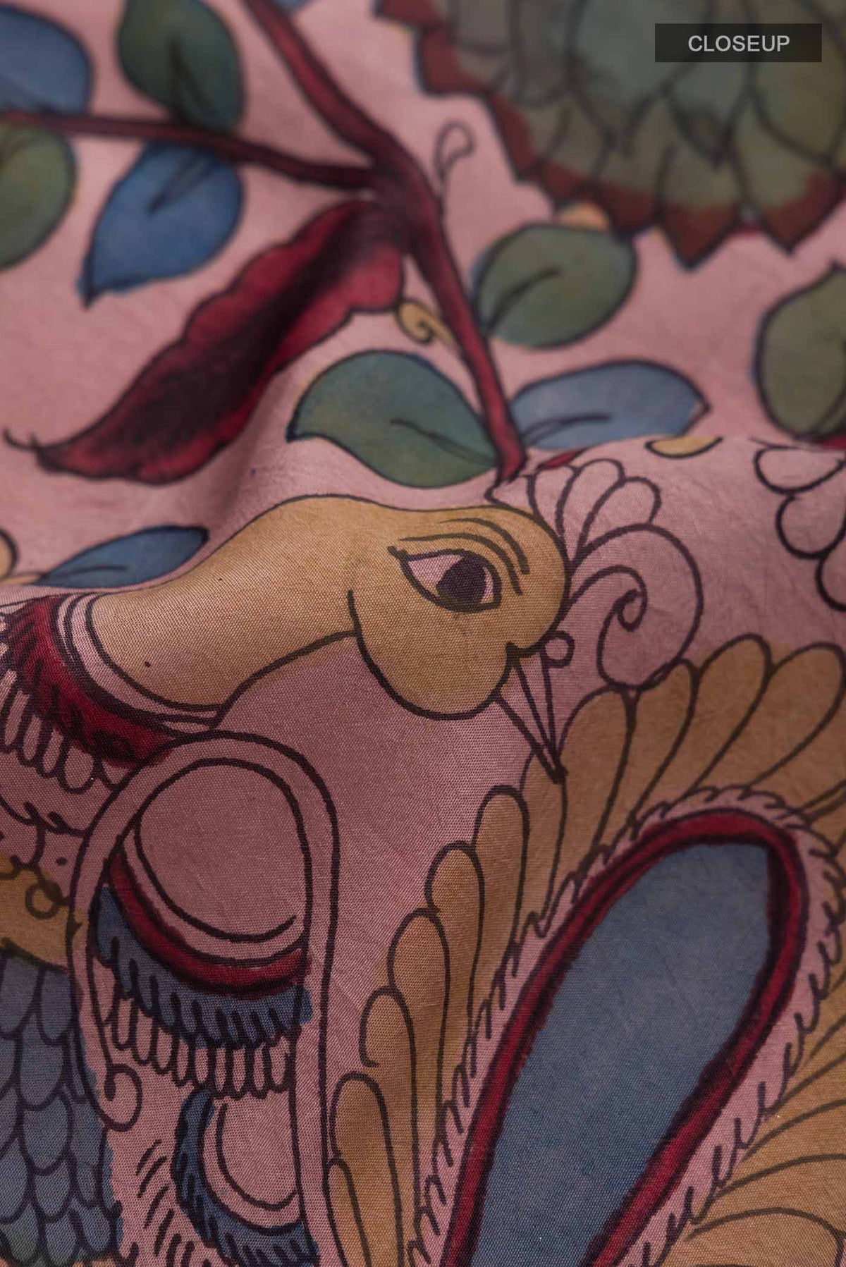 Close up of Mauve Kanchipuram Silk Saree with kalamkari Print on the body and Zari Border displaying folds