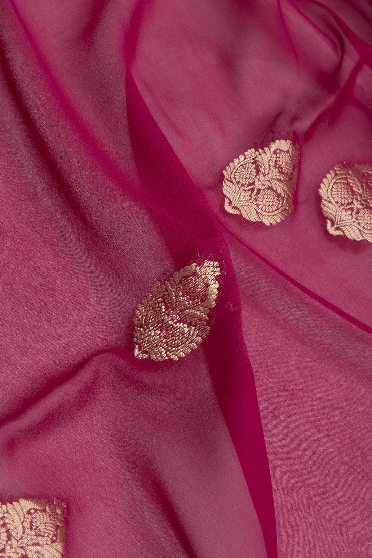 Close up of Magenta Mysore Georgette Saree with Zari Butta on the body and Zari Border.  displaying folds