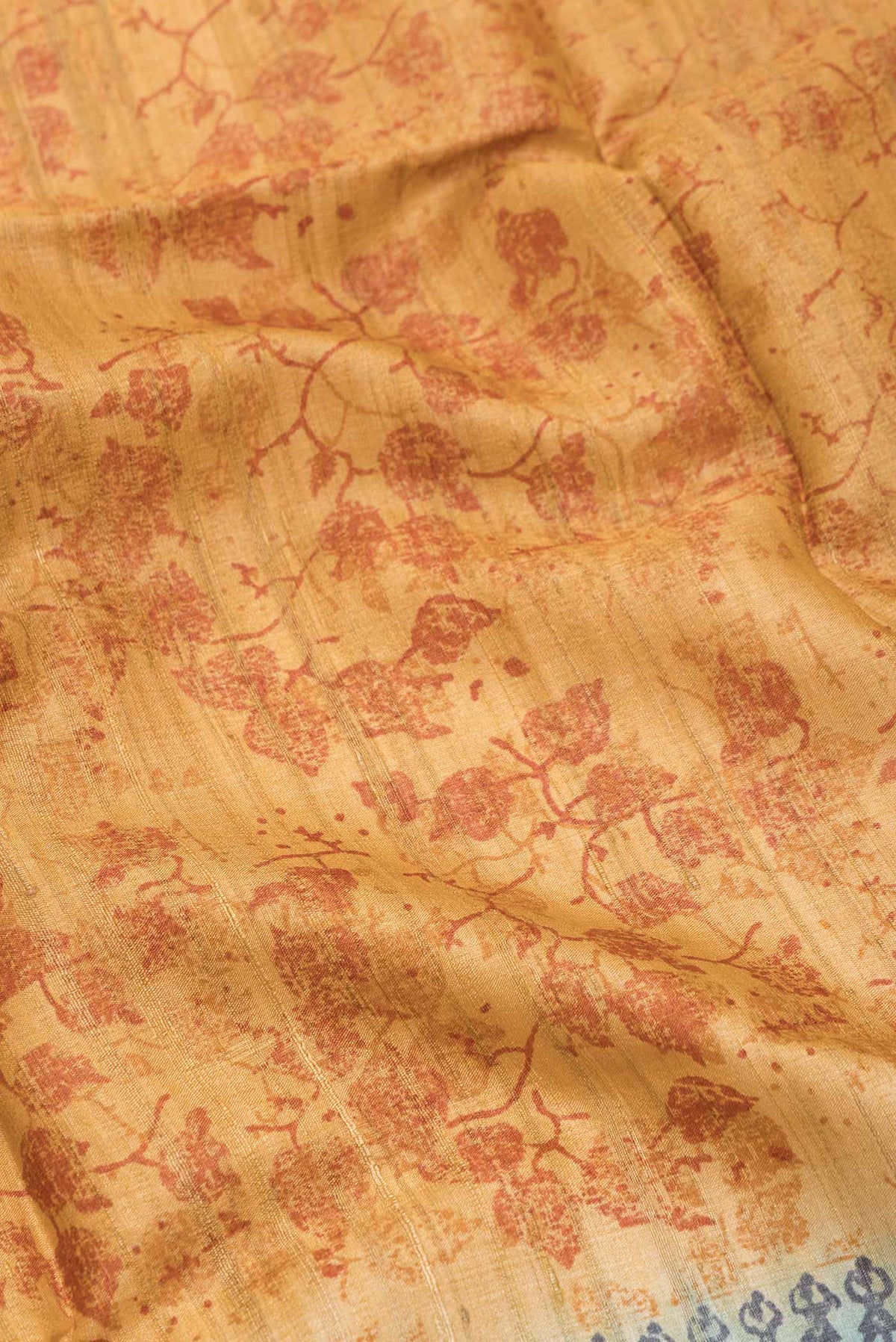 Close up of Mustard Dual Tone Tussar Silk SareePrinted design on the body and Printed Border displaying folds