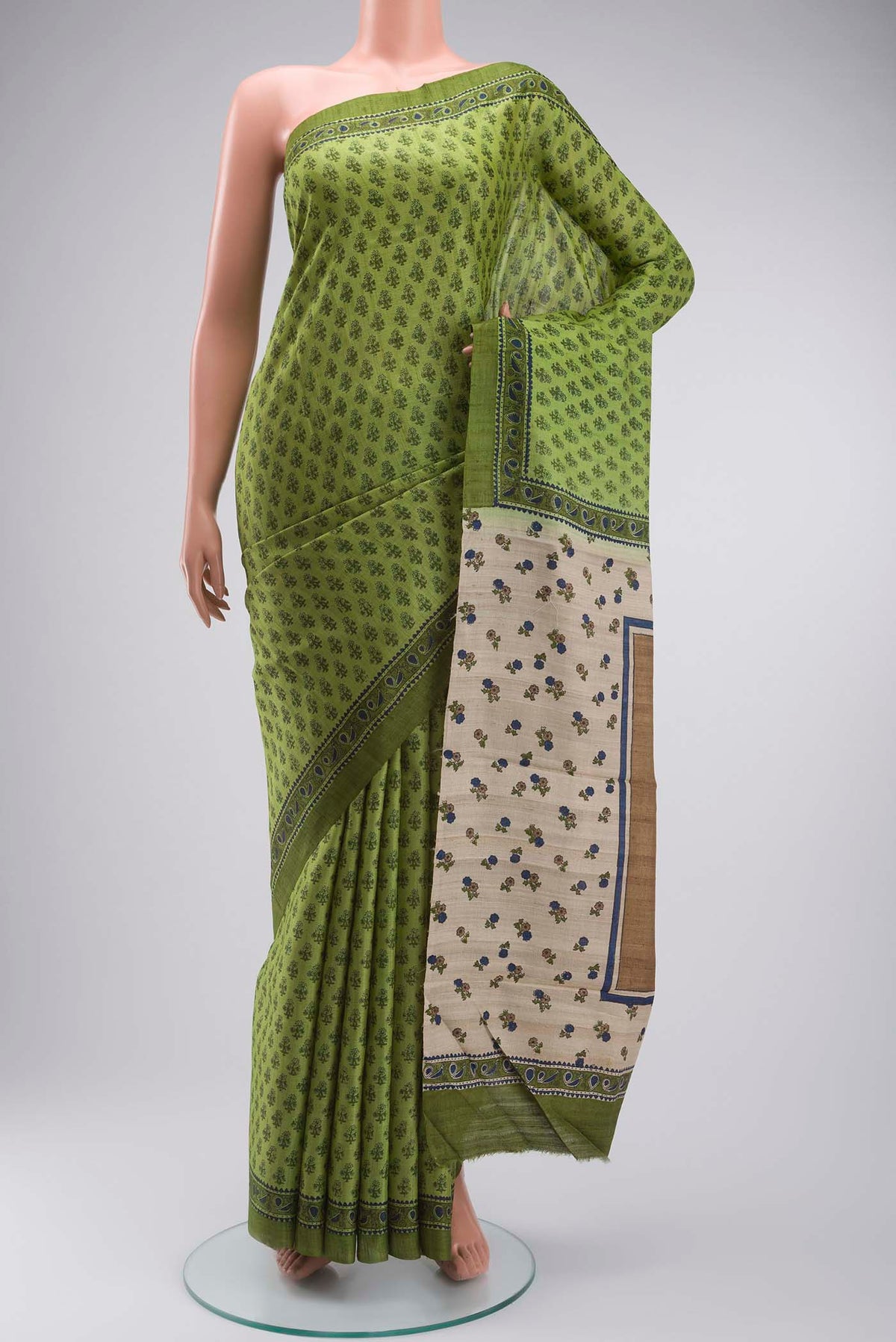 Green Tussar Silk Saree with Printed design on the body and Plain Border displayed on a mannequin