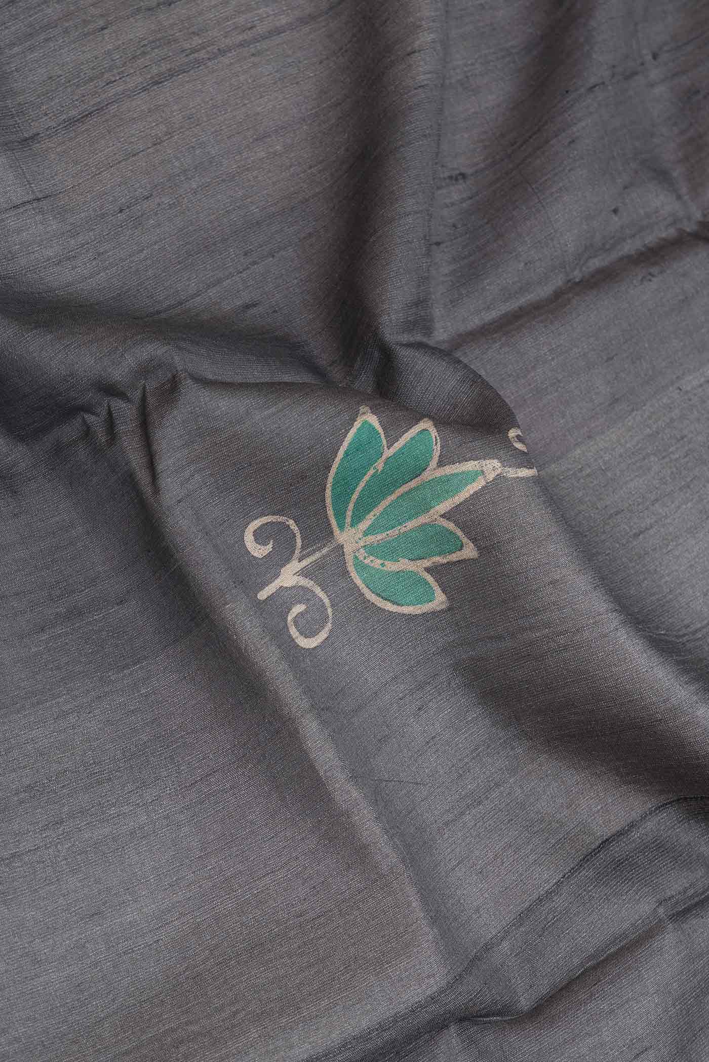Close up of Grey Dual Tone Tussar Silk SareePrinted design on the body and Zari Border displaying folds