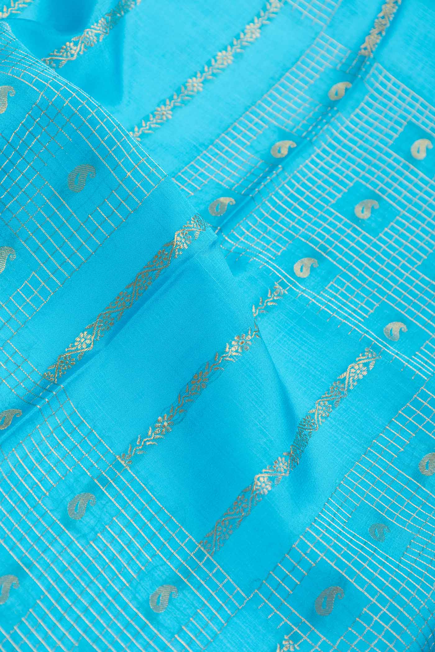 Close up of Sky Blue Dual Tone Mysore Crepe Saree with Stripes on the body and Zari Border displaying folds