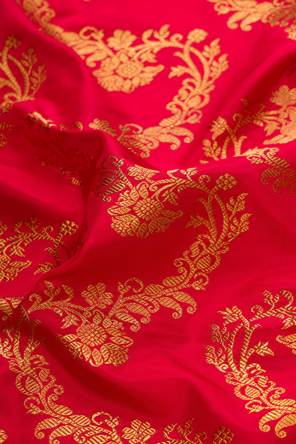Close up of Pure Silk Pure Zari Red Dual Tone Kanjivaram Saree with Zari Brocade on the body and Zari Border.  displaying folds