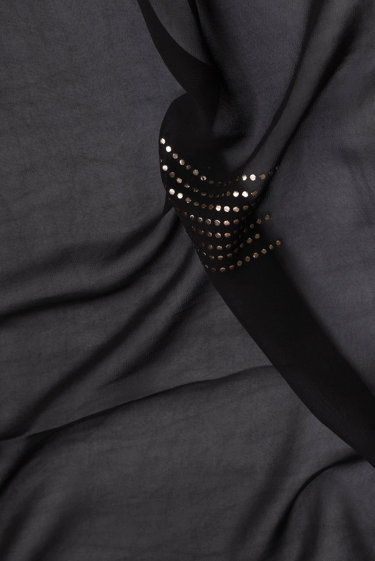 Close up of Black Dual Tone Mysore Georgette Saree with Embroidery on the body and Fancy Border.  displaying folds