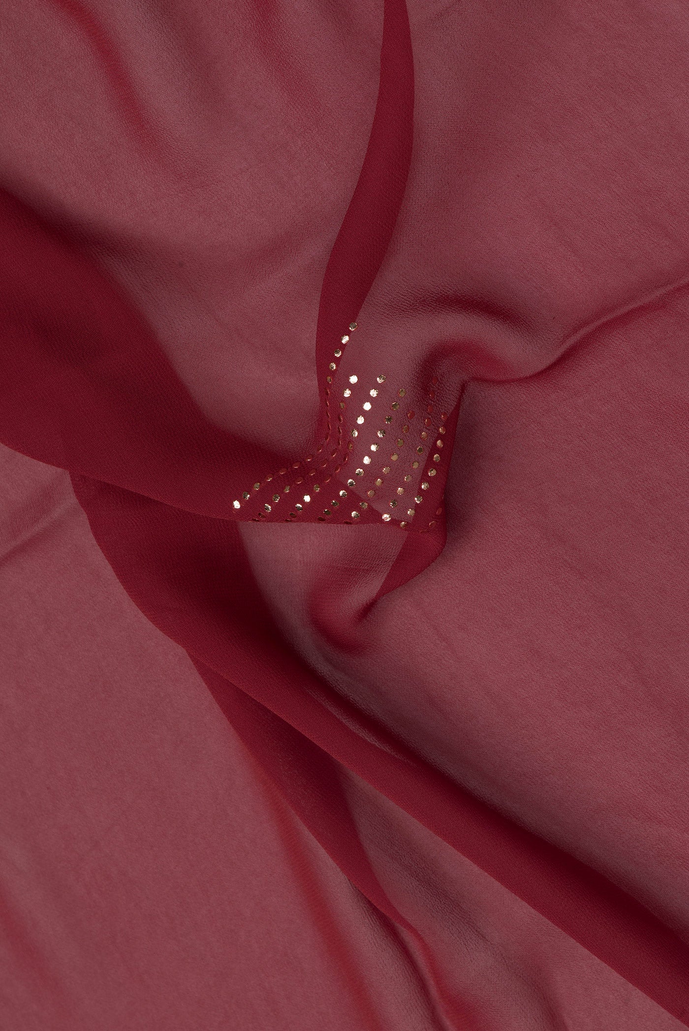 Close up of Maroon Dual Tone Mysore Georgette Saree with Embroidery on the body and Fancy Border.  displaying folds