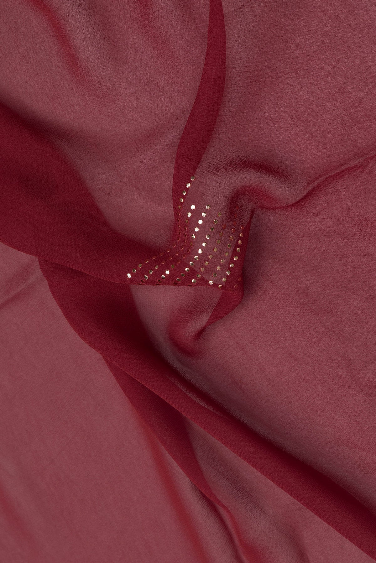 Close up of Maroon Dual Tone Mysore Georgette Saree with Embroidery on the body and Fancy Border.  displaying folds
