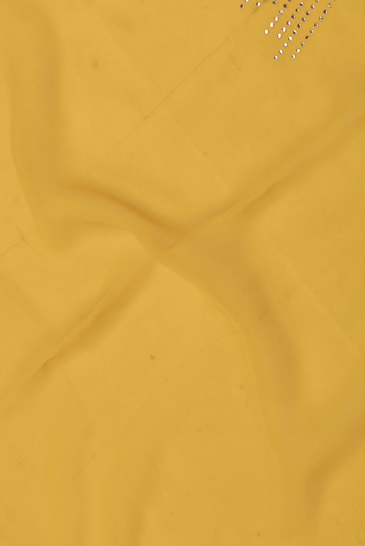 Close up of Yellow Dual Tone Georgette Saree with Embroidery on the body and Embroidery Border displaying folds
