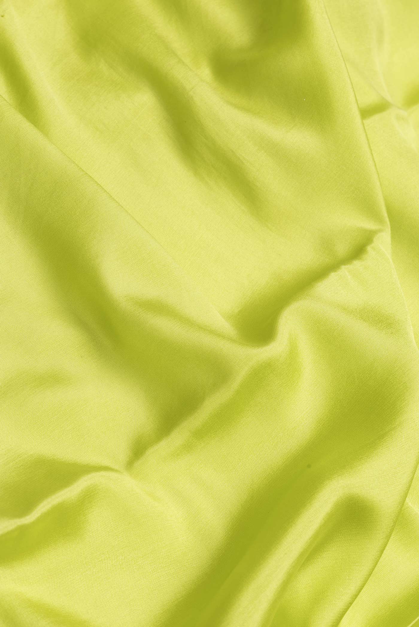 Close up of Parrot Green Dual Tone Mysore Silk Saree with Plain Body and Zari Border.  displaying folds