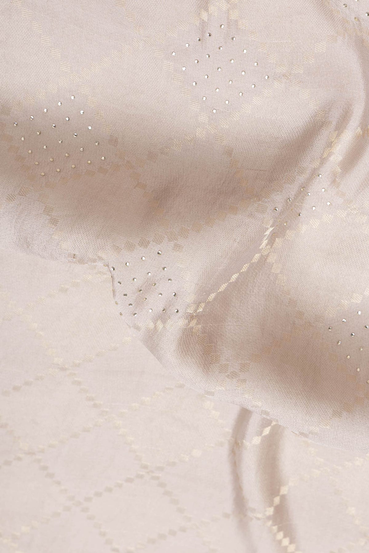 Close up of Beige Dual Tone Mysore Georgette Saree with Zari Brocade on the body and Zari Border.  displaying folds