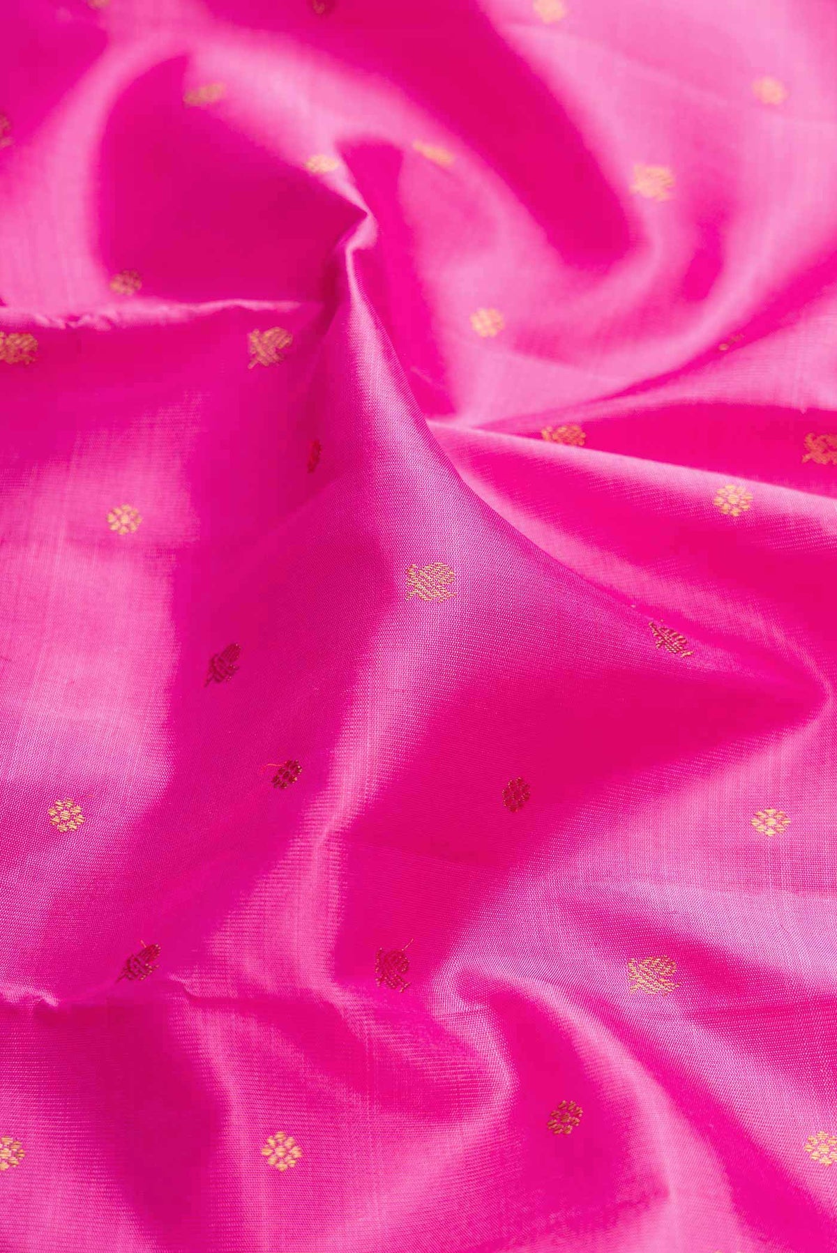 Close up of Pure Silk Pure Zari Rose pink Kanchipuram Saree with Zari Butta on the body and Zari Border displaying folds