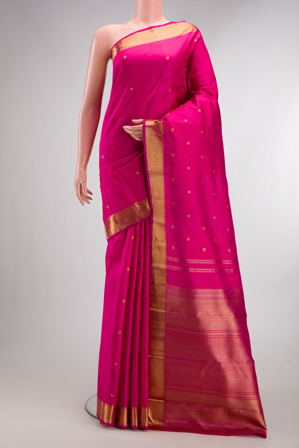 Pure Silk Pure Zari Pink Kanjivaram Saree with Zari Butta on the body and Zari Border.  displayed on a mannequin
