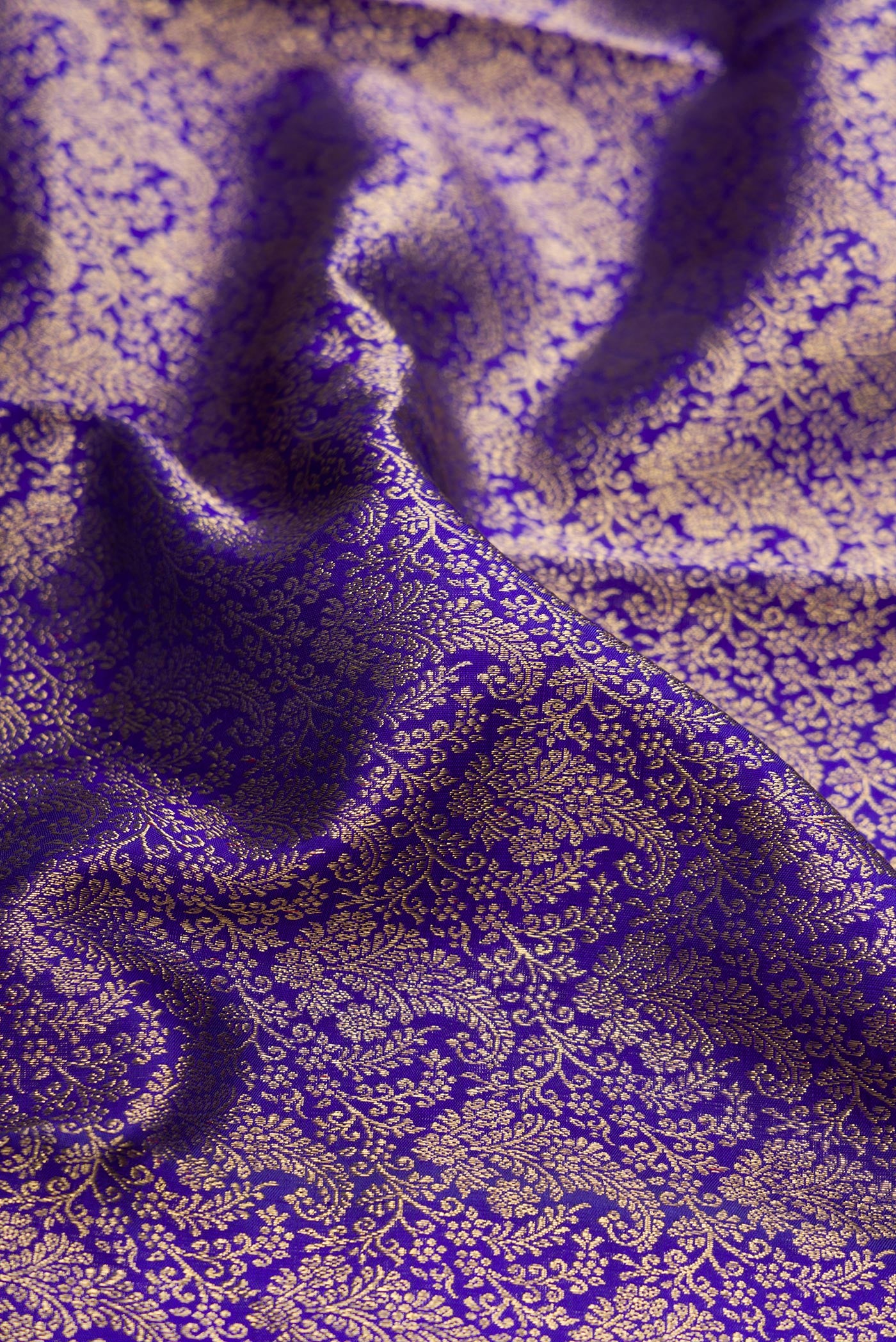 Close up of Pure Silk Pure Zari Royal Blue Dual Tone Kanjivaram Saree with Zari Brocade on the body and Zari Border.  displaying folds