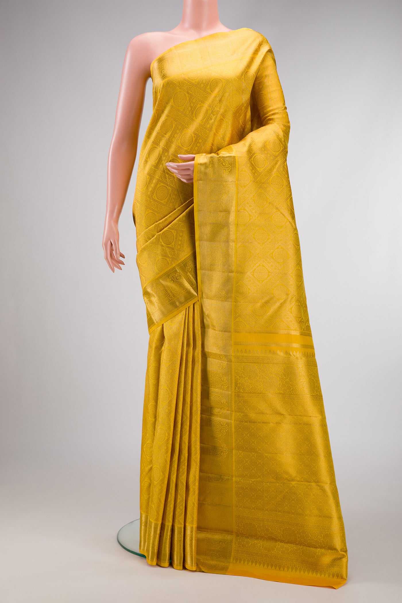 Yellow Dual Tone Kanjivaram Silk Saree with Zari Brocade on the body and Zari Border.  displayed on a mannequin