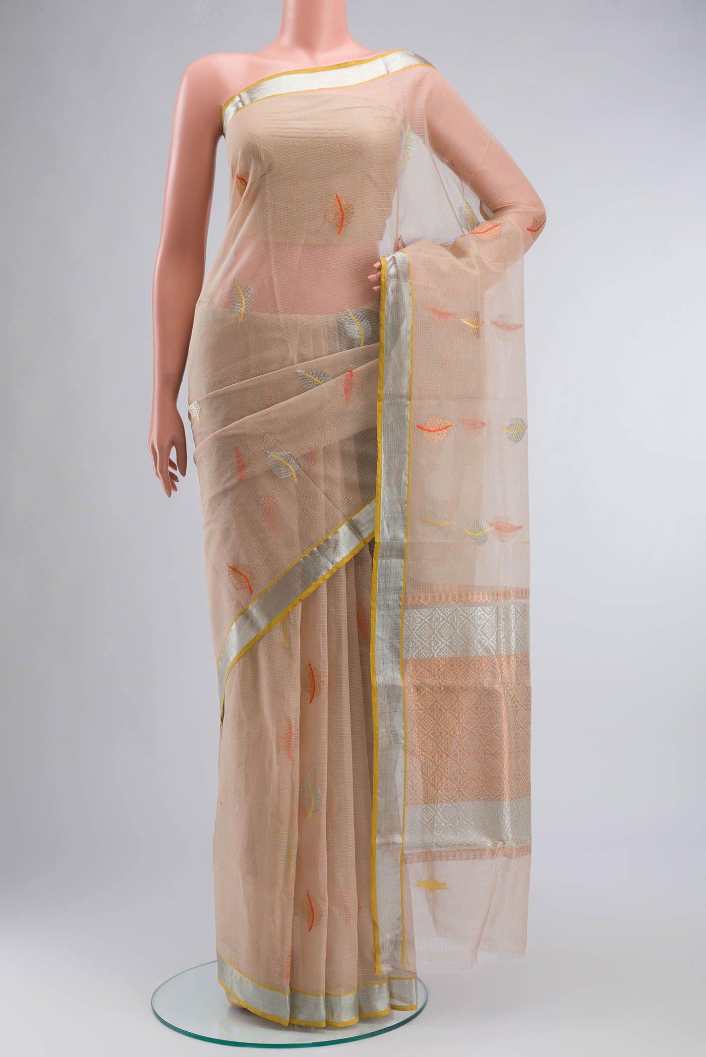 Beige Kota Silk Saree with Zari And Thread Butta on the body and Zari Border displayed on a mannequin