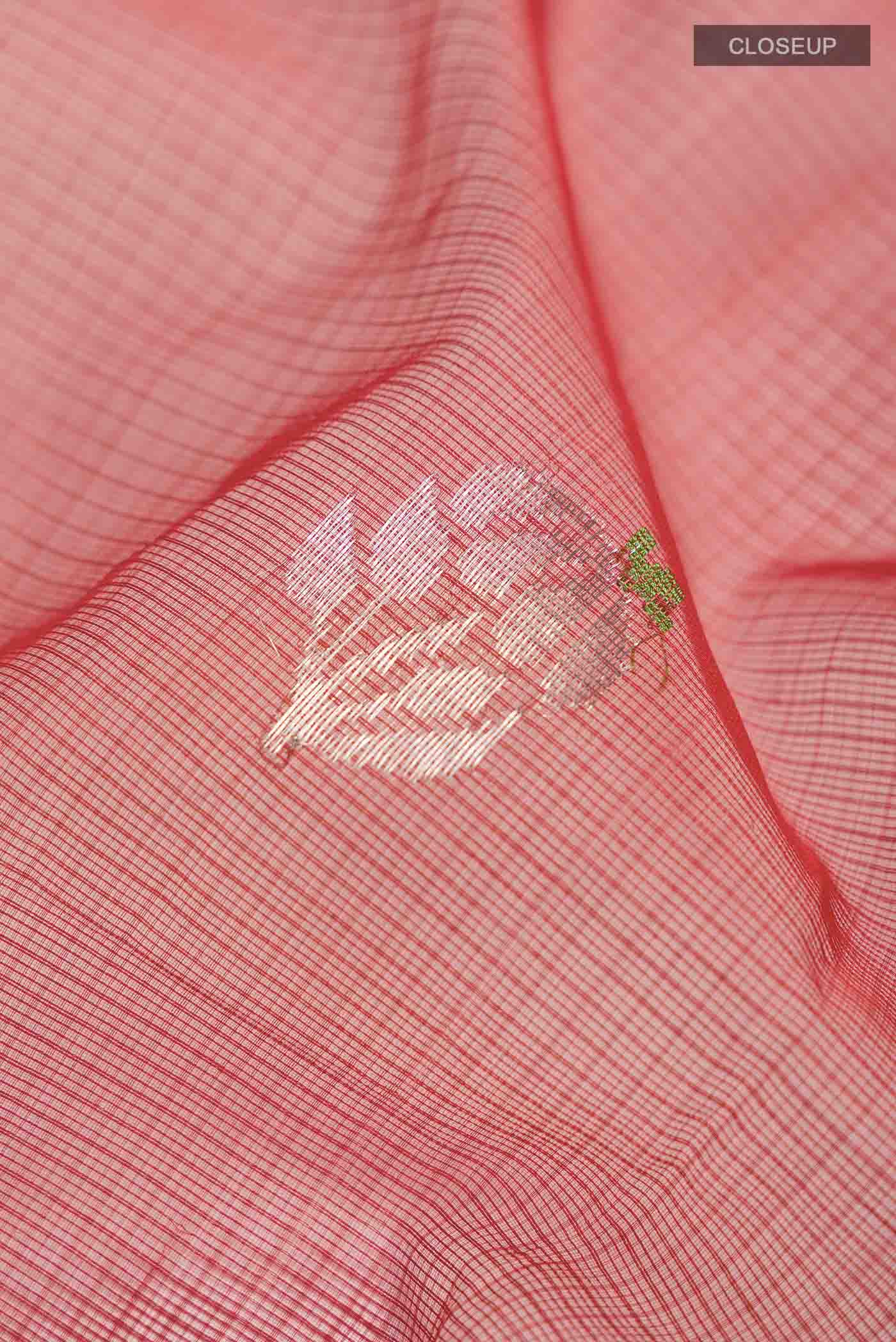 Close up of Maroon Kota Silk Saree with Zari And Thread Butta on the body and Zari Border displaying folds