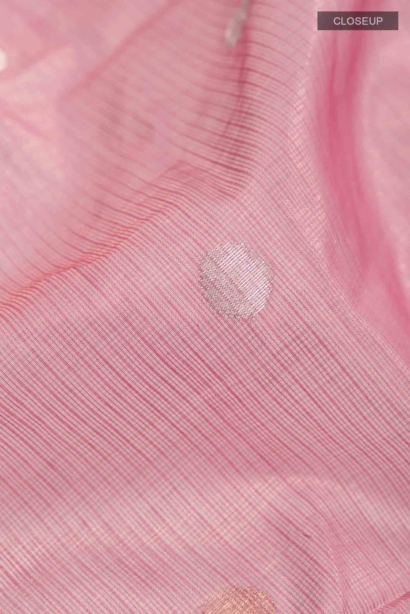 Close up of Pink Kota Silk Saree with Zari Butta on the body and Zari And Thread Border displaying folds