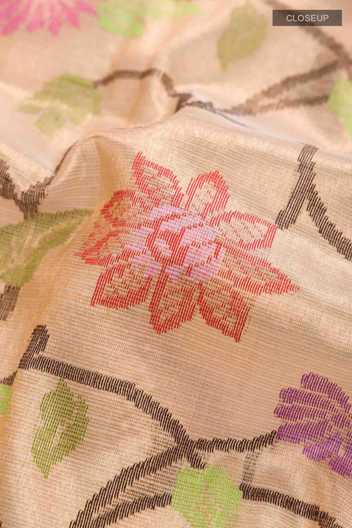 Close up of Peach Kota Silk Saree with Jacquard With Zari Butta on the body and Zari Border displaying folds