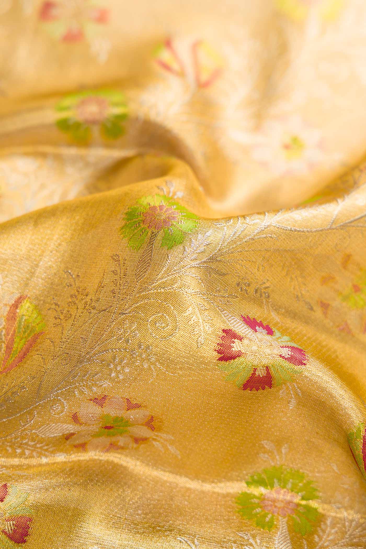 Close up of Gold Dual Tone Kanjivaram Tissue Silk Saree with Zari Brocade on the body and Zari Border.  displaying folds
